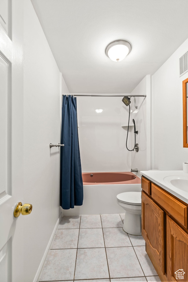 Full bath featuring shower / bath combo, vanity