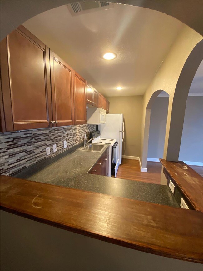 Kitchen featuring visible vents, decorative backsp