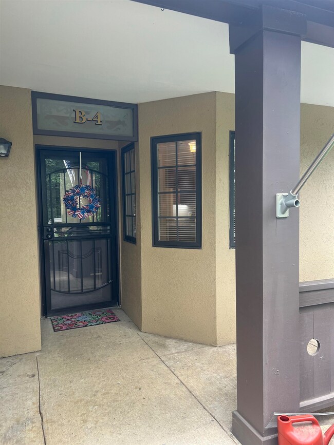 Entrance to property featuring stucco siding