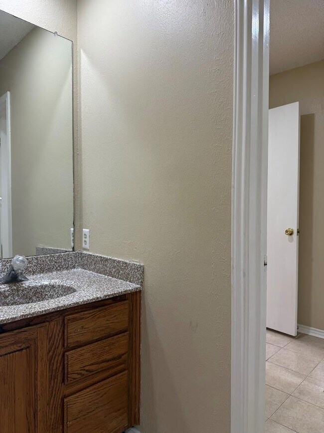Bathroom with vanity and tile patterned flooring