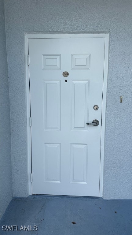 Entrance to property with stucco siding