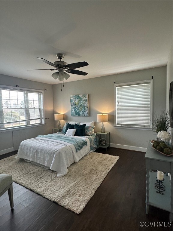 Bedroom featuring dark wood-type flooring, baseboa