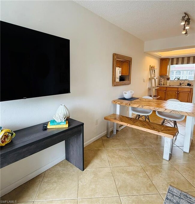Dining area featuring light tile patterned floorin
