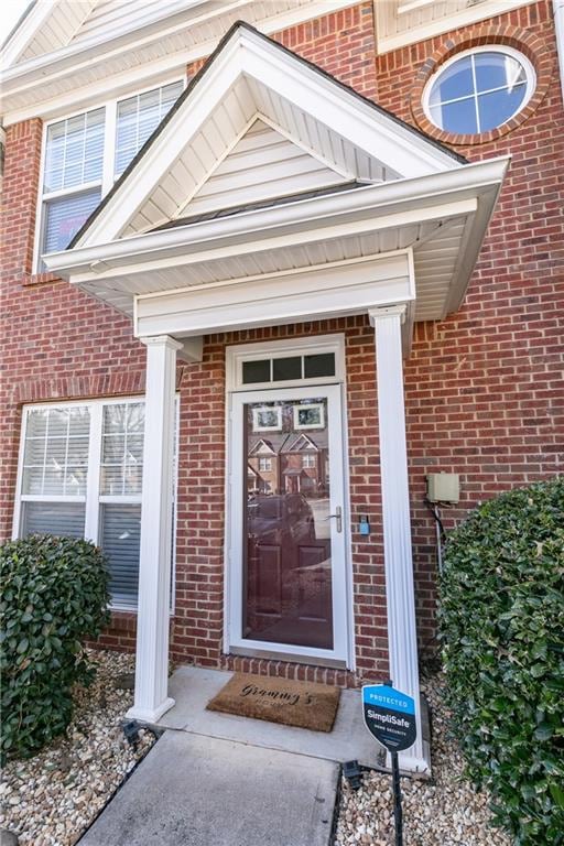Doorway to property with brick siding