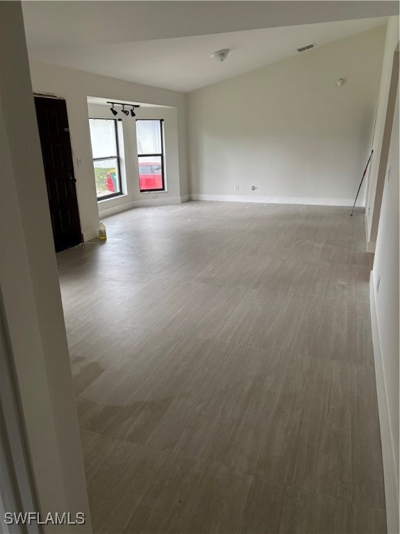 Unfurnished room featuring wood finished floors and baseboards