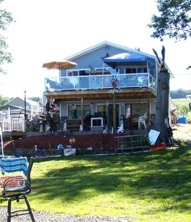 PORCH, UPPER DECK, LARGE YARD, MORE PATIOS ON SIDE