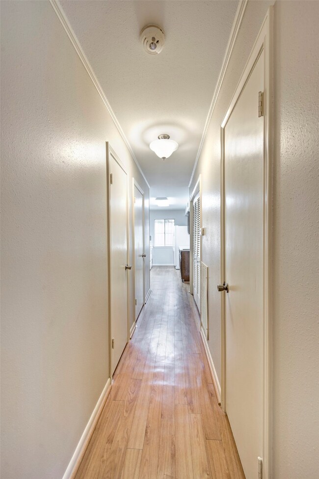 Downstairs hallway has beautiful faux wood floorin