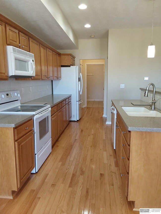 Overlooks living area, offers solid surface countertops