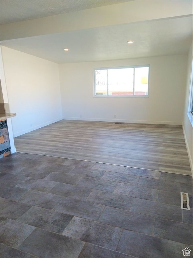 Empty room with baseboards and recessed lighting