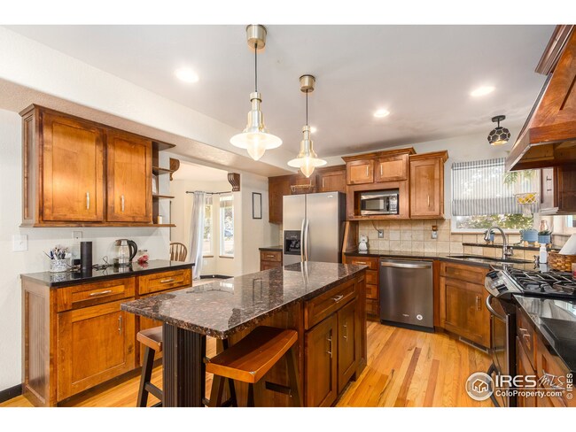 Plenty of cabinet and counter space in this big kitchen. Windows let in lots of natural light.