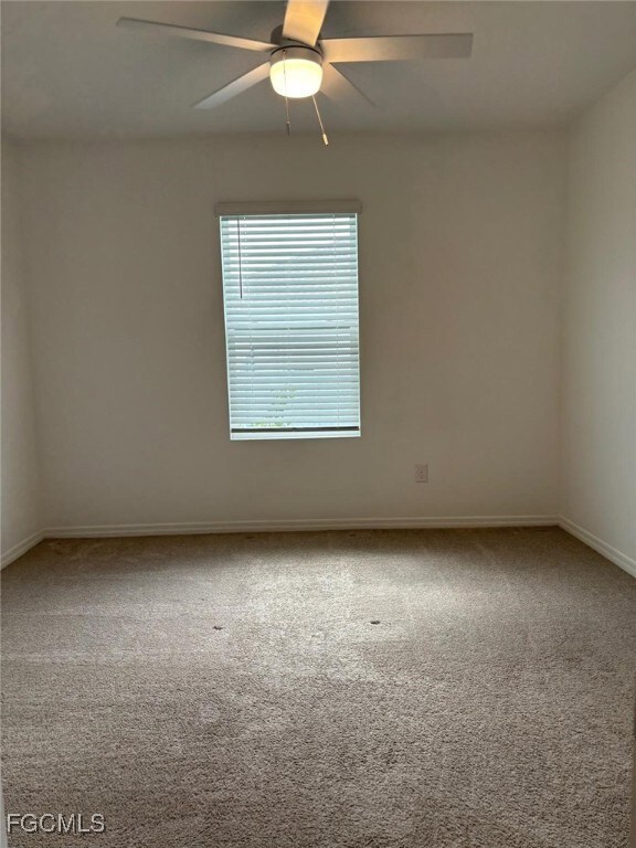 Unfurnished room with light carpet and ceiling fan