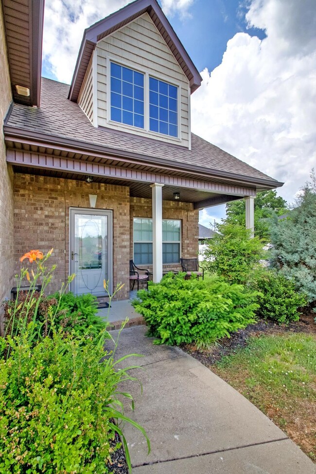 Beautiful mature landscaping across the entire front of the home.  The dormer lets tons of natural light into the home. 