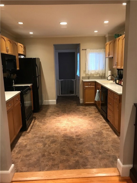 Recessed lighting, kitchen opens up to living room