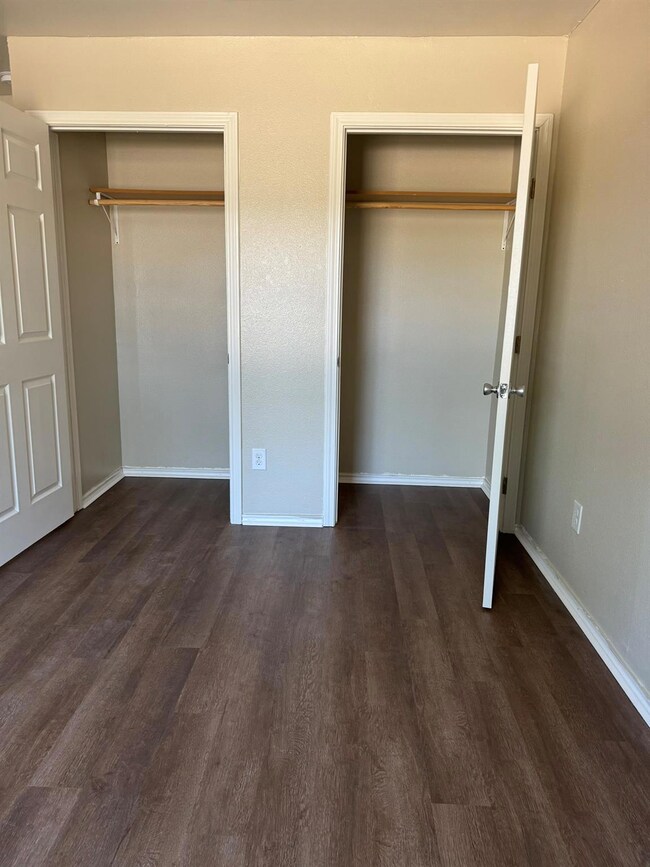 Unfurnished bedroom featuring multiple closets an