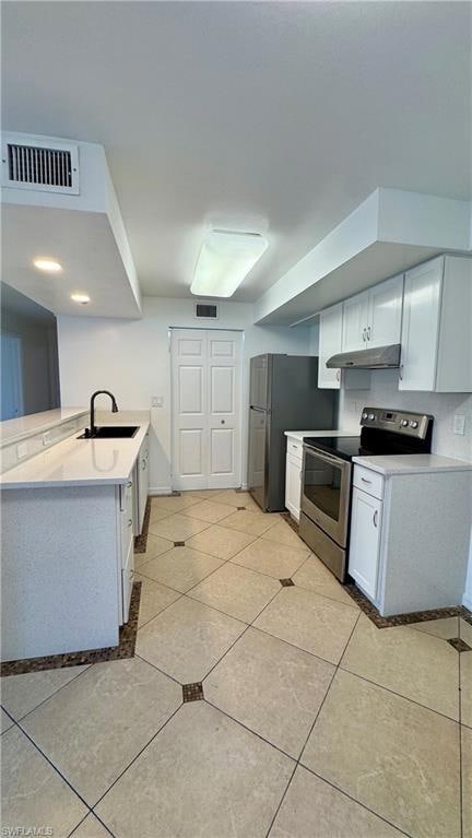 Kitchen featuring light tile patterned floors, sta