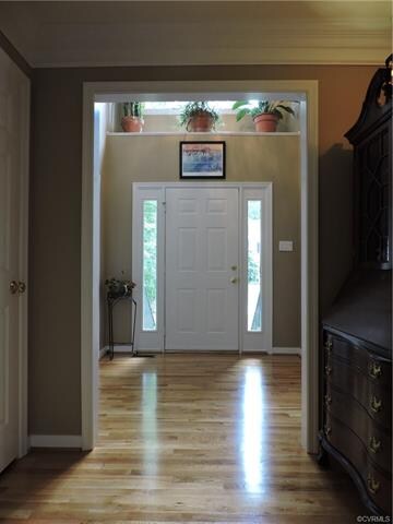 Welcoming foyer with walkway, door on left is coat