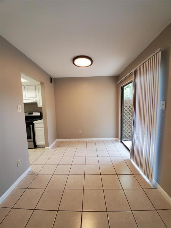 Unfurnished room with light tile patterned floors