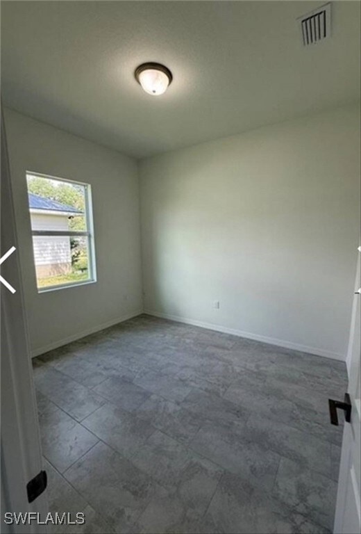 Unfurnished room with baseboards