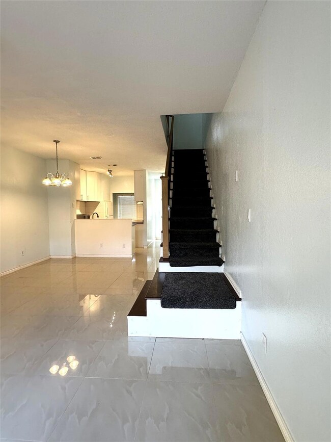 Stairs with an inviting chandelier