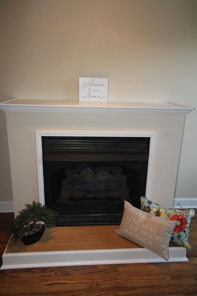 Gas Fireplace in living room with hardwood floors.
