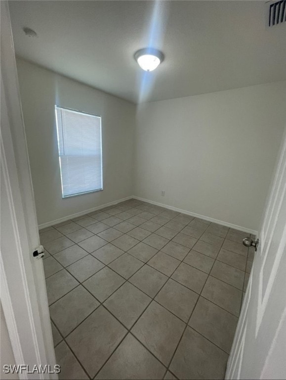 Empty room featuring light tile patterned floors a