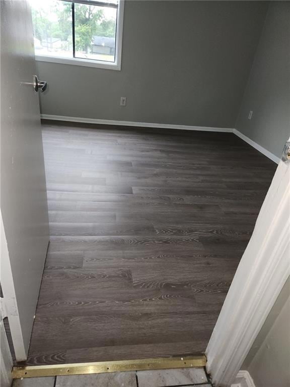 Spare room with baseboards and wood finished floor