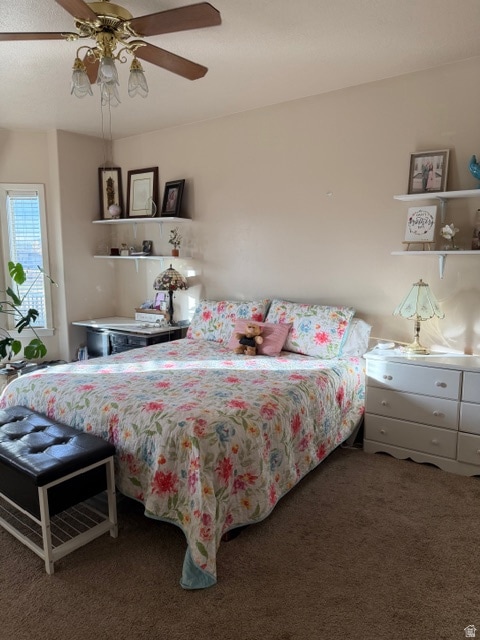Bedroom featuring carpet flooring, ceiling fan, and a textured ceiling