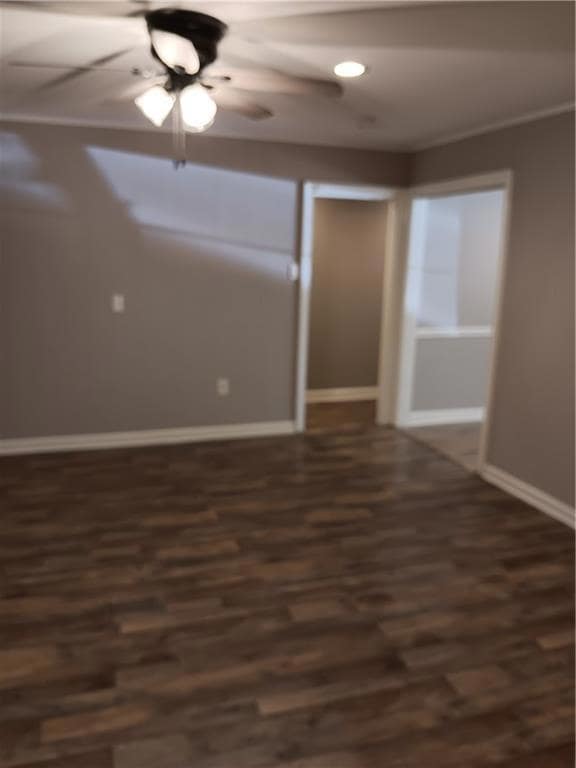 Dining room view features laminated wood flooring, ceiling fan and fresh paint.