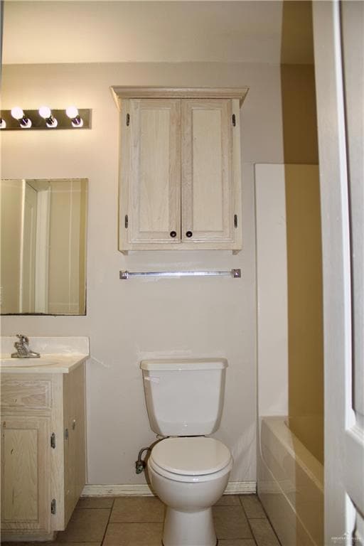 Full bathroom featuring baseboards, toilet, tile patterned flooring, and vanity