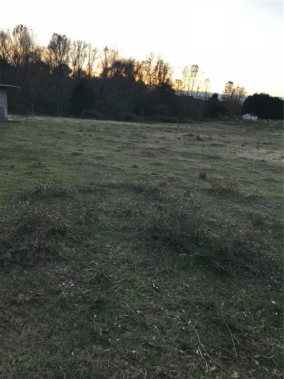 Yard at dusk with a rural view