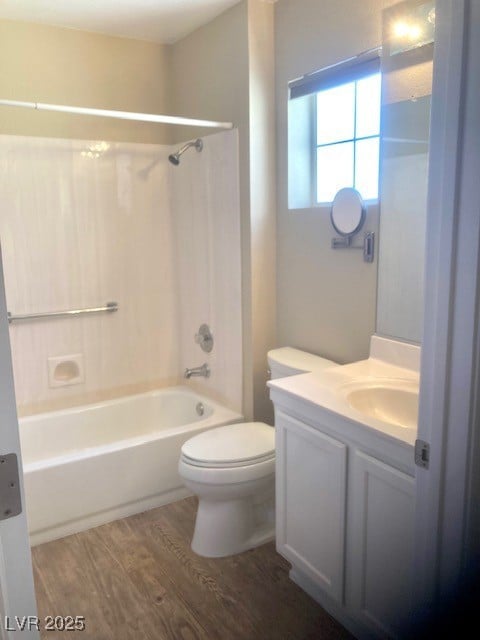 Full bathroom with wood finished floors, vanity, t