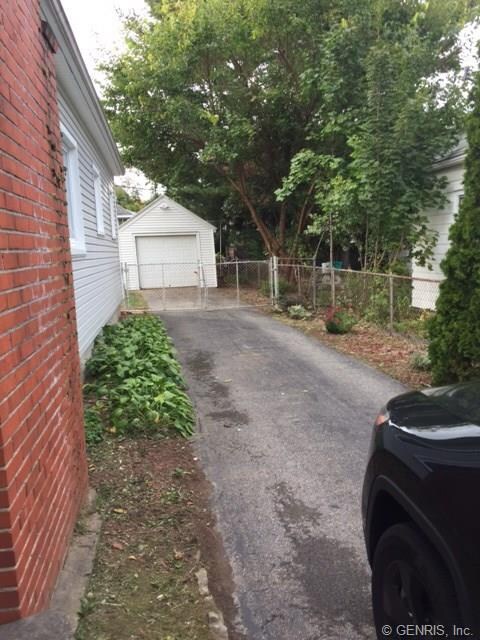 View from the driveway looking at the fenced in ba