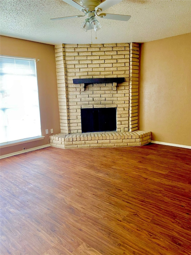 natural light, brick fireplace and ceiling fan.