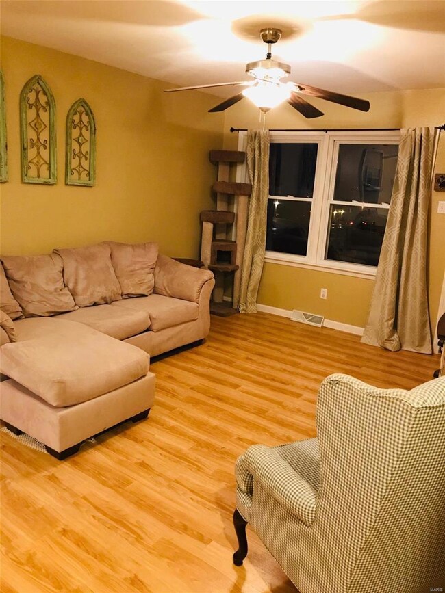 Nice size living room with newer tilt in windows a