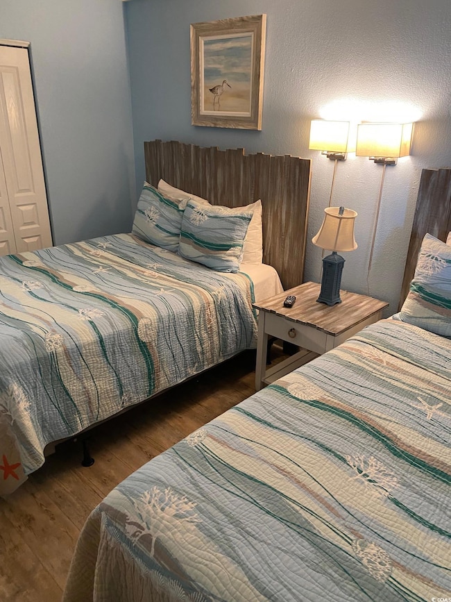 Bedroom with dark wood-type flooring