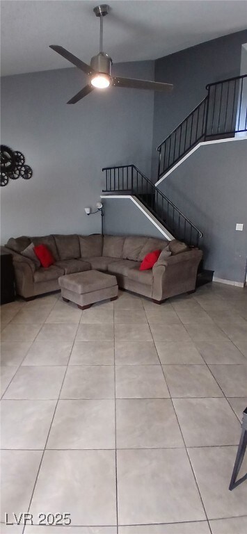 Living area featuring tile patterned flooring, sta