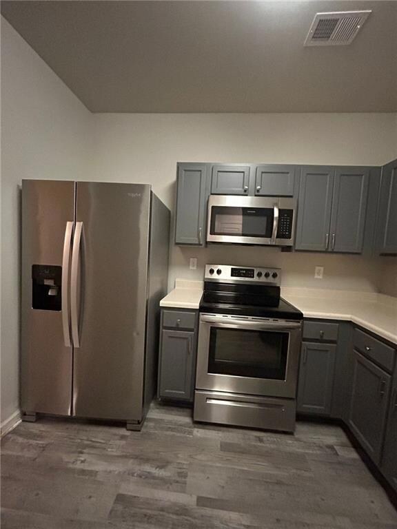 Kitchen featuring stainless steel appliances, gray