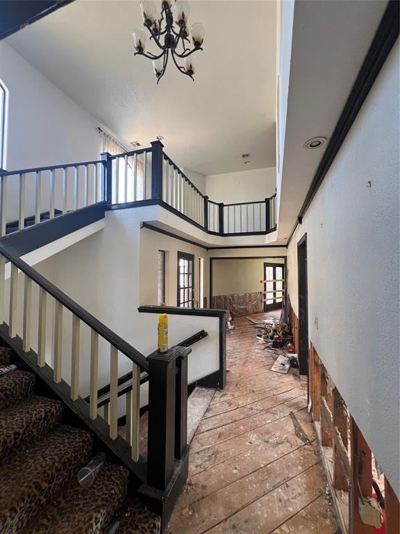 Stairway featuring a towering ceiling, hardwood / 