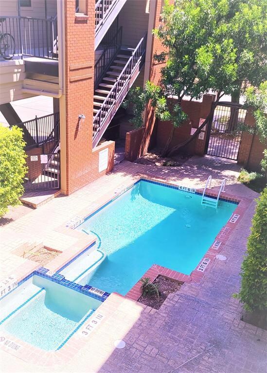 View of swimming pool with stairs, a pool with co