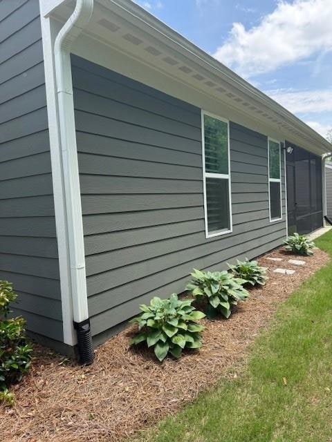 View of home's exterior with a sunroom