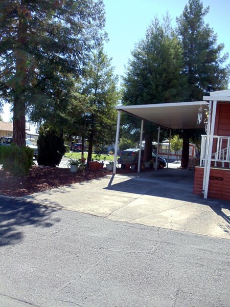 Landscape corner lot w carport view