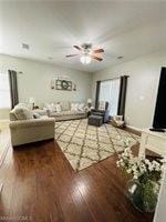 Living room with wood finished floors, ceiling fan, and healthy amount of natural light