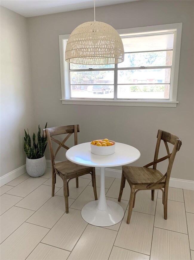 Dining space with light tile patterned floors