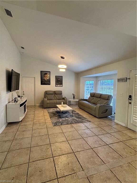 Living area with lofted ceiling, light tile patter