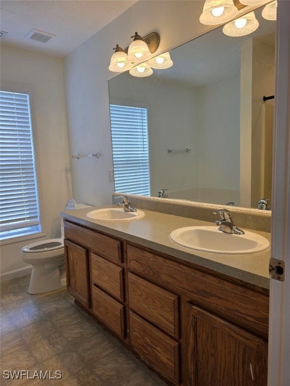 Full bathroom featuring double vanity and a chandelier