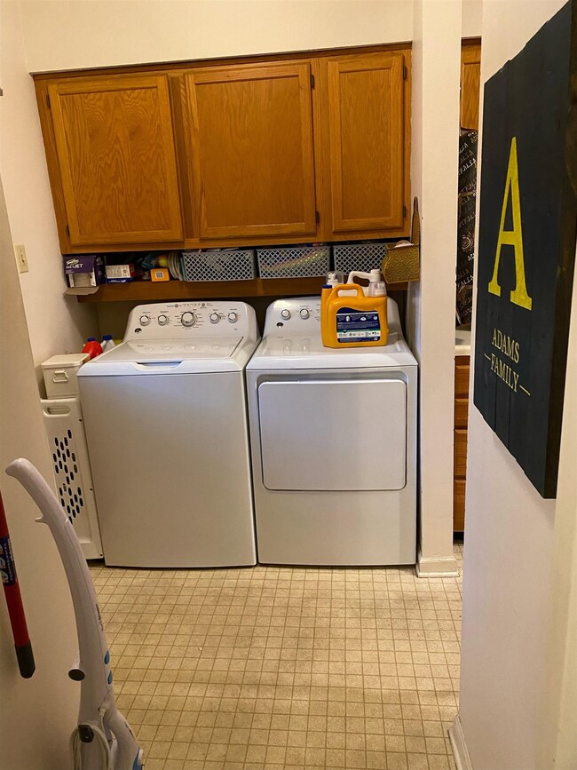 Laundry area with cabinets and independent washer 