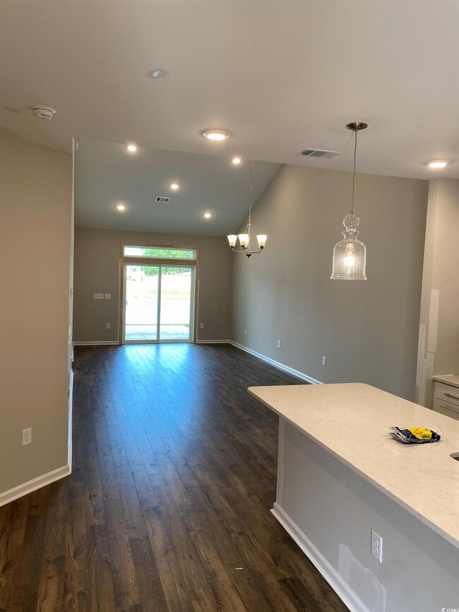 Interior space featuring dark wood-type flooring, 