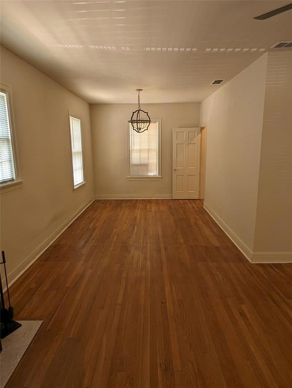 Unfurnished room with wood finished floors, baseb