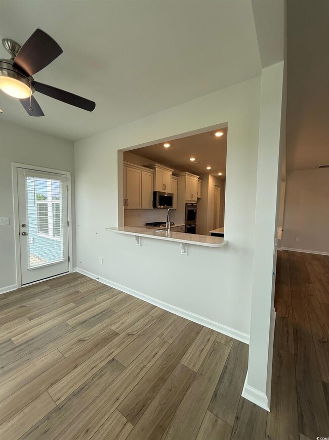 Kitchen with a breakfast bar, light countertops, a