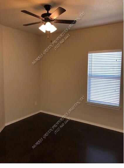 Unfurnished room with baseboards and a ceiling fan